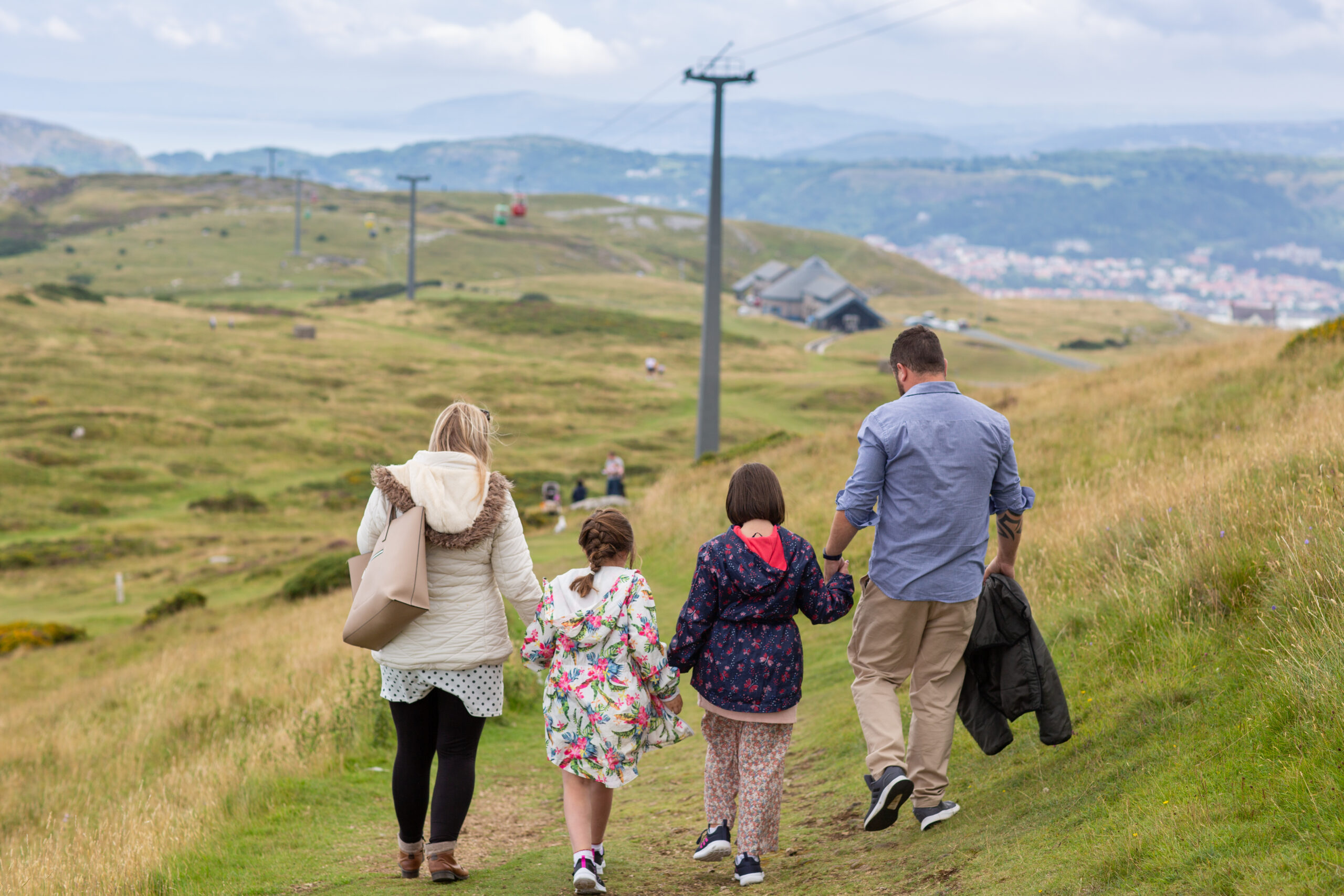 Family walking away on hillside