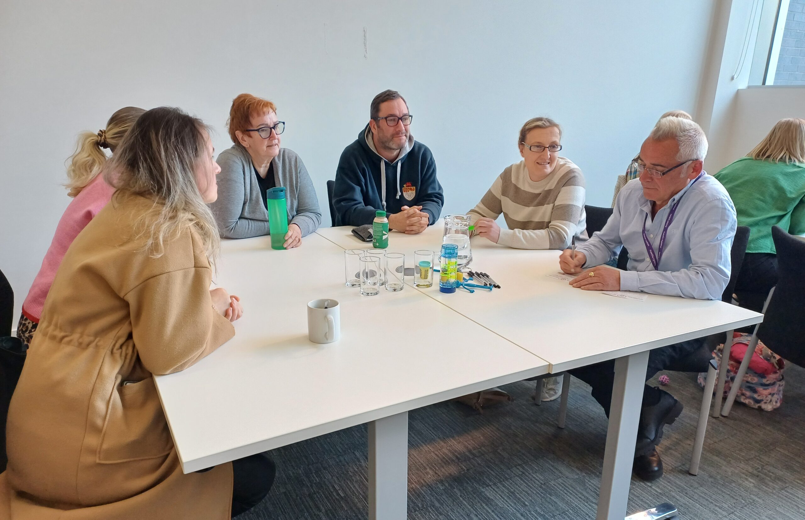 foster carers sat around a table talking