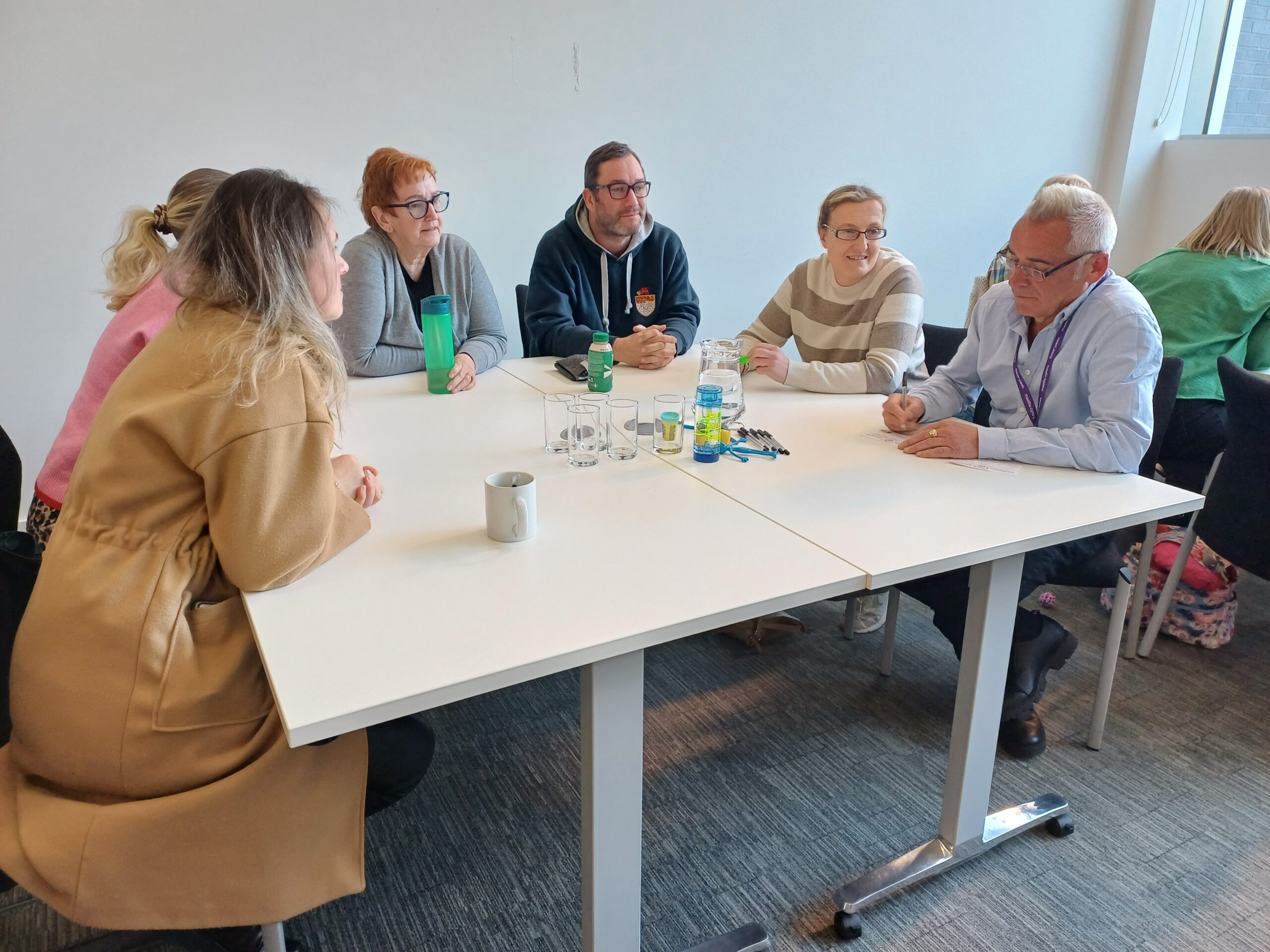 foster carers sat around a table talking